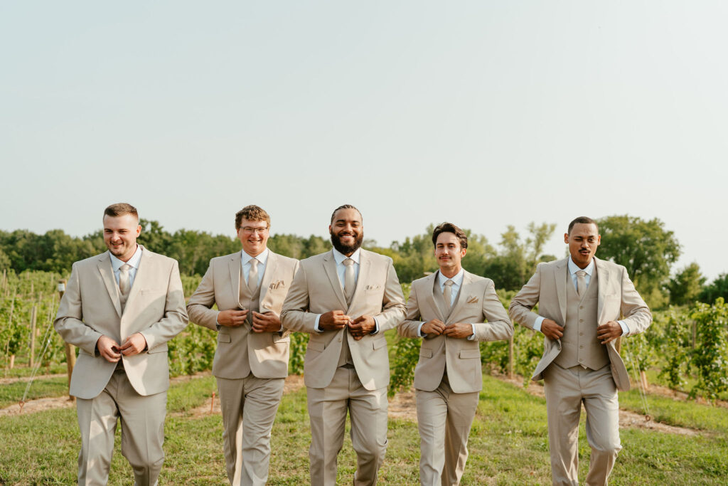 groomsmen and groom in taupe suits
