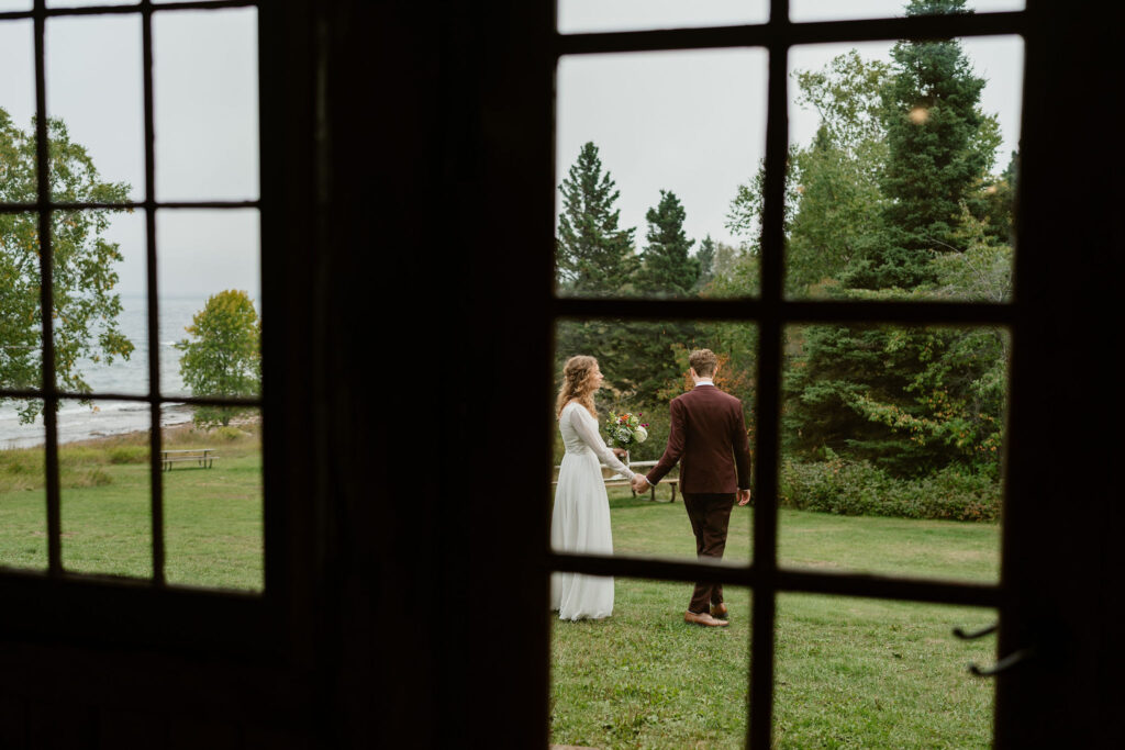 A cozy picnic shelter adorned with autumnal foliage serves as the backdrop for Annie and Josiah's north shore elopement ceremony in minnesota surrounded by close friends and family.