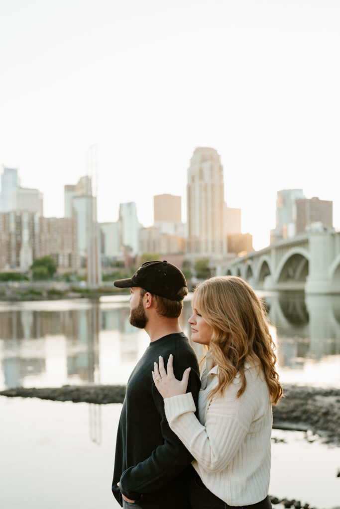 Jona and Cyle share a sweet moment against the iconic Stone Arch Bridge in downtown Minneapolis.