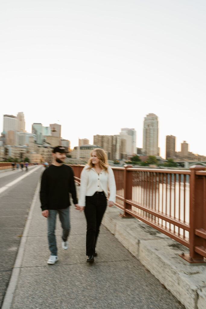 Jona and Cyle share a sweet moment against the iconic Stone Arch Bridge in downtown Minneapolis.