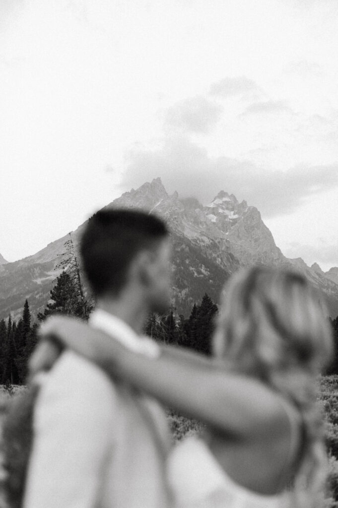 Cam and Ashley embrace at sunrise in Grand Teton National Park at Cascade Canyon.