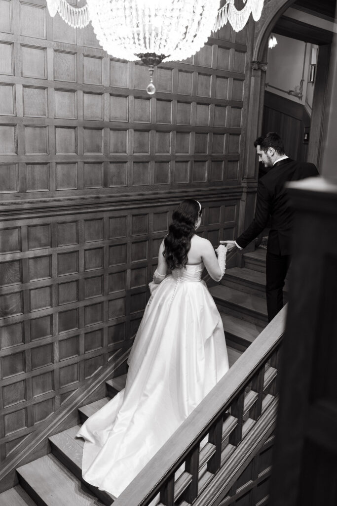 A grand staircase inside The Van Dusen Mansion, adorned with elegant details, perfect for wedding photos.