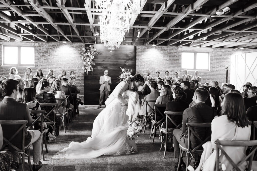 Bride and groom kiss on their way back down the aisle