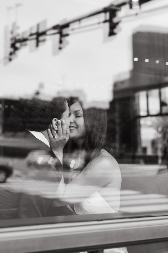 Couple photos through the window of the Hewing Hotel bar