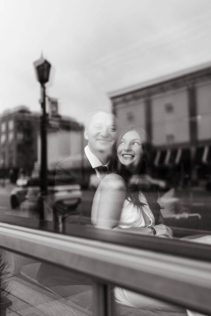 Couple photos through the window of the Hewing Hotel bar