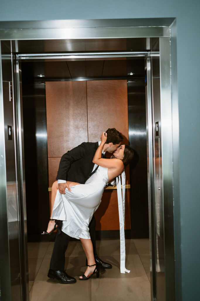 Couple poses in the elevator of the hotel