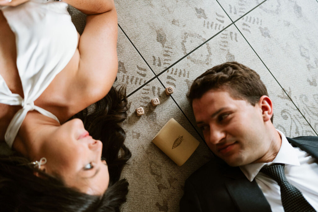 couple lays by their custom Yahtzee die with their wedding date