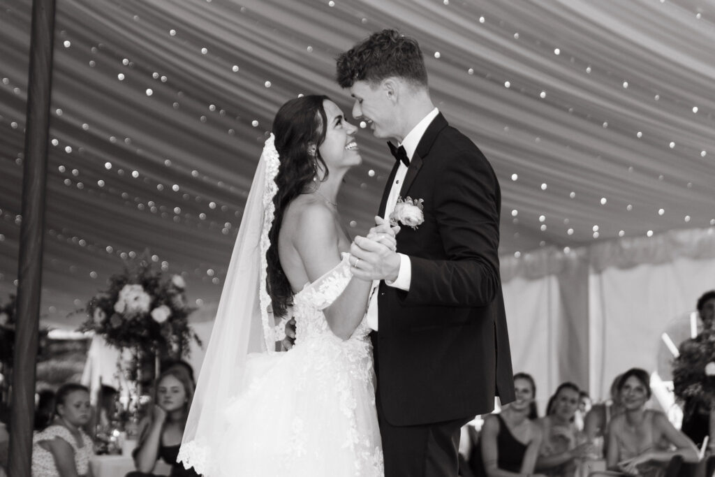 A classic wedding reception under a white tent in a Wisconsin backyard