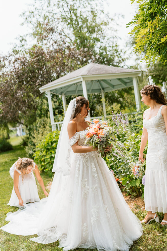 A bride walks through a stunning backyard with colorful florals