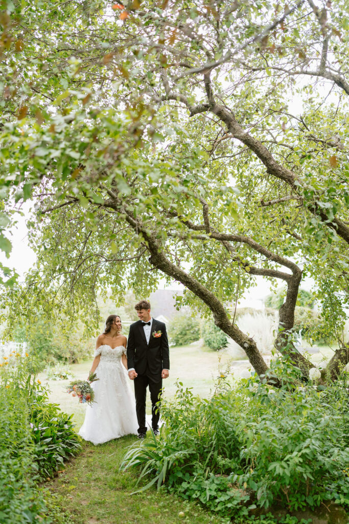 Bride and groom have some portraits in a pristinely kept garden in a Wisconsin backyard