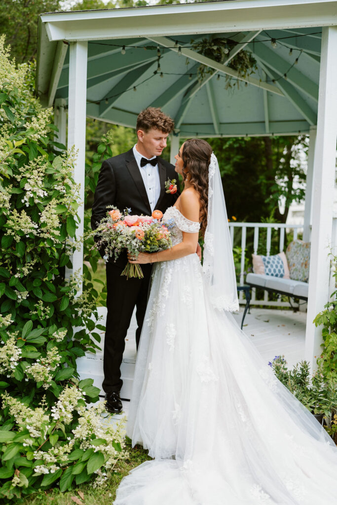 Bride and groom have some portraits in a pristinely kept garden in a Wisconsin backyard