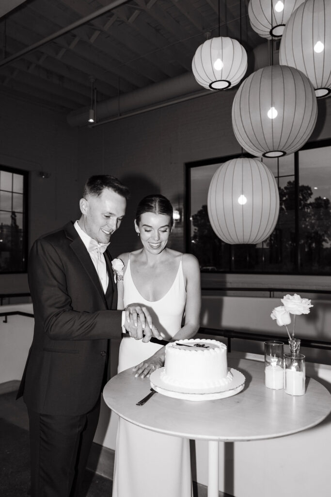 Documentary style wedding reception shots of bride and groom cutting the cake