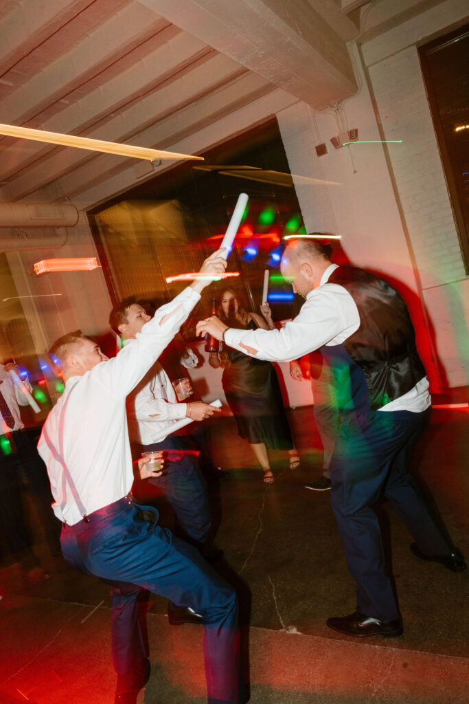 Documentary style wedding reception shots of guests partying on the dance floor