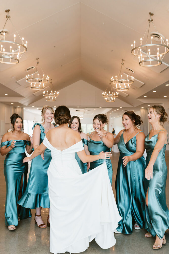 Bride and bridesmaids first look with bridesmaids in jewel toned dresses