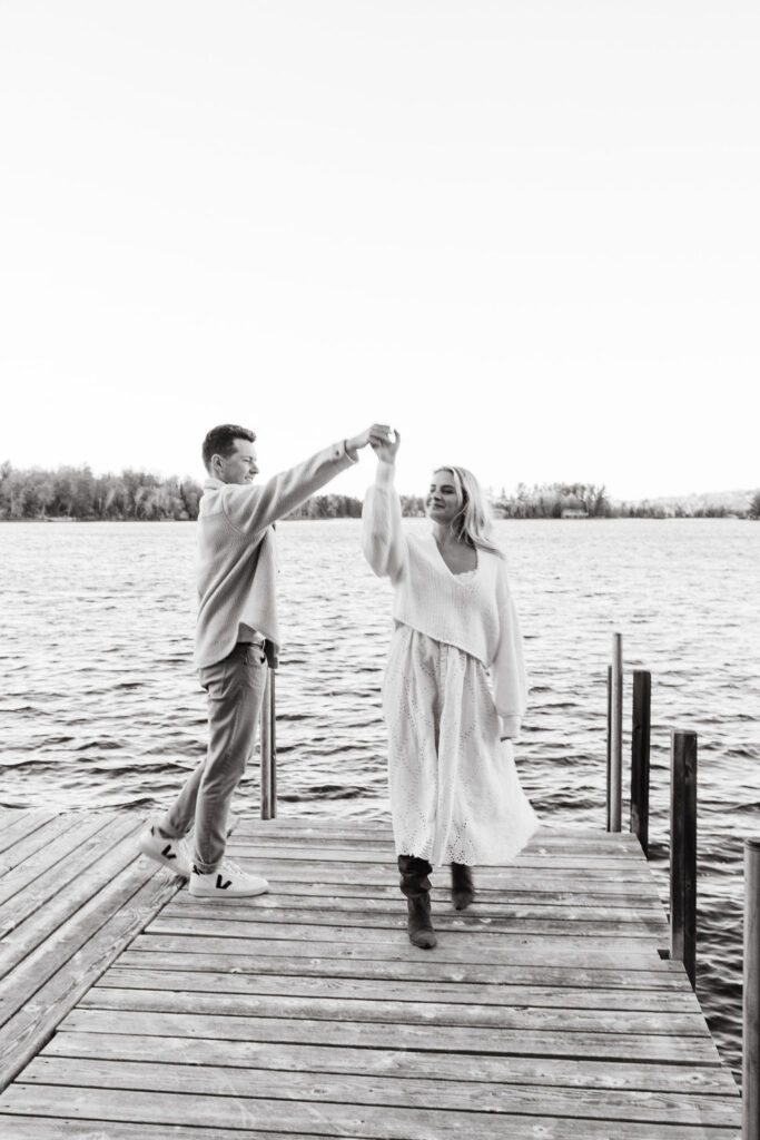 Couple walks across the dock at Lake Vermilion for their fall engagement photos