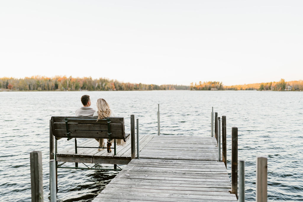 Couple takes fall engagement photos on the dock at Lake Vermilion