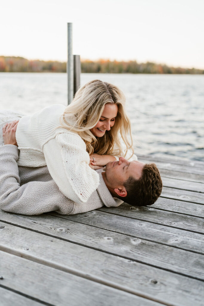 Couple takes fall engagement photos on the dock at Lake Vermilion