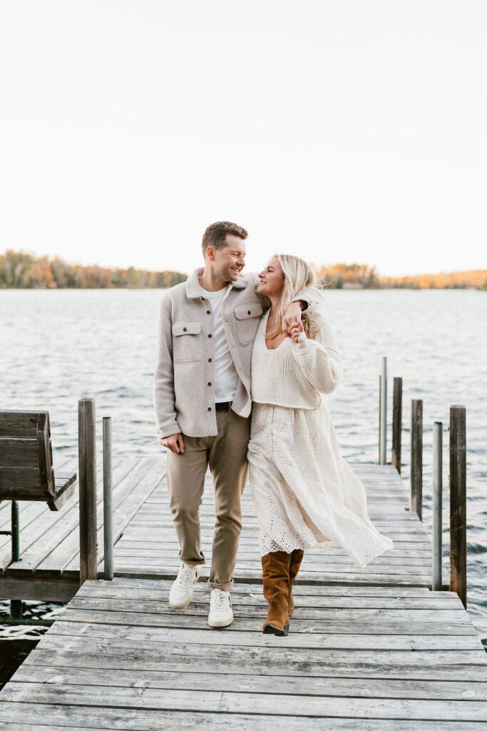 Couple takes fall engagement photos on the dock at Lake Vermilion