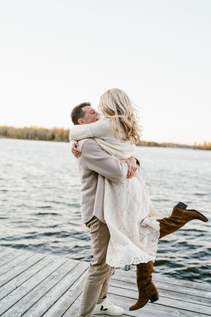 Couple takes fall engagement photos on the dock at Lake Vermilion