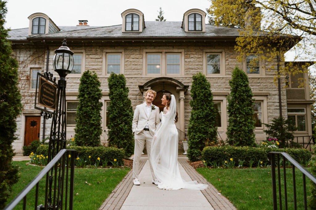 Couple stands outside of Twin Cities wedding venue St Paul College Club