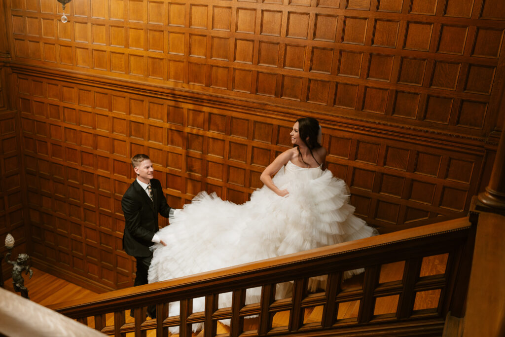 Couple walks up the stairs of Van Dusen mansion in Twin Cities