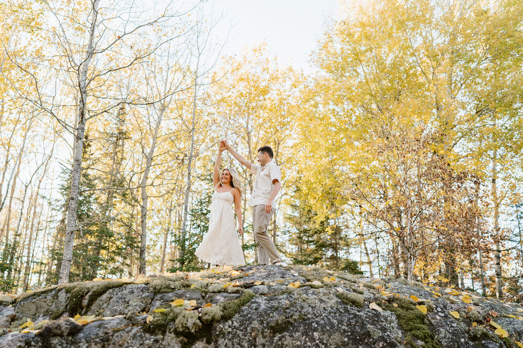 Couple takes engagement photos in the fall foliage at their family's Minnesota cabin on the lake