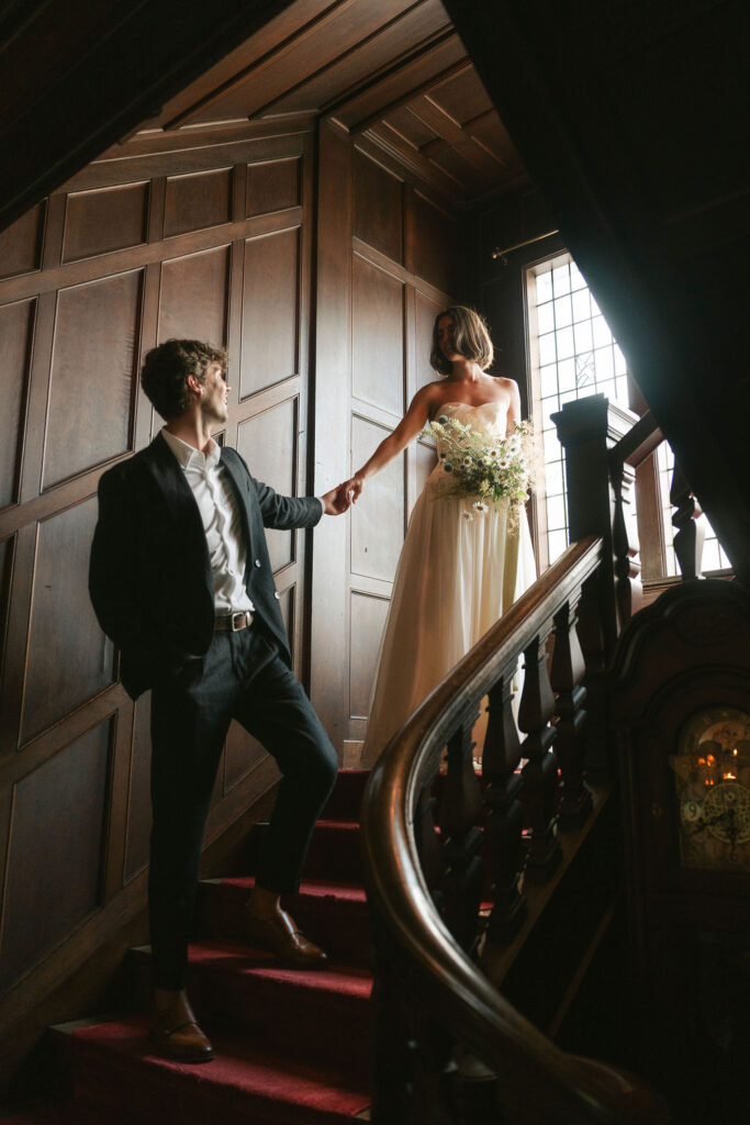 Couples walks the stairs of a mansion wedding venue in Minneapolis