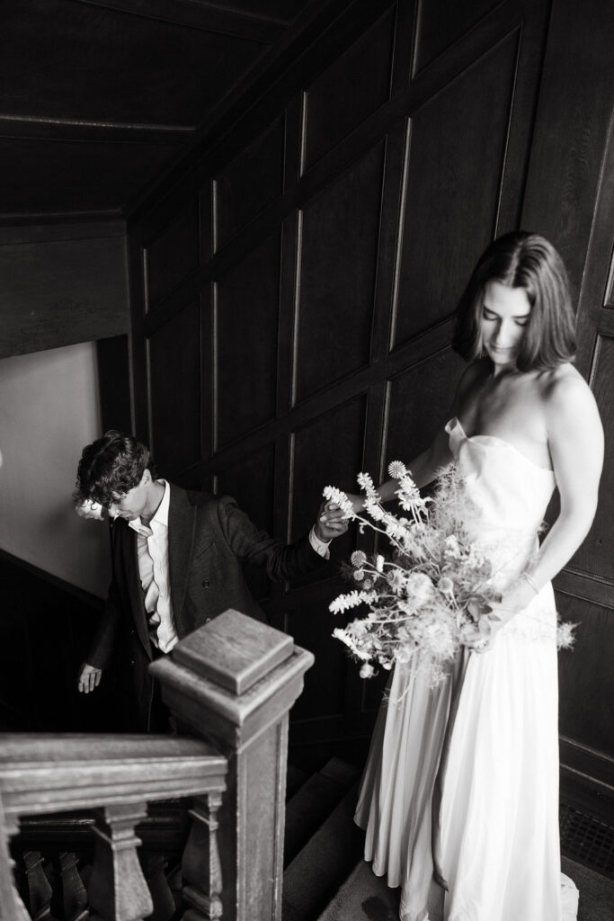 Couples walks the stairs of a mansion wedding venue in Minneapolis