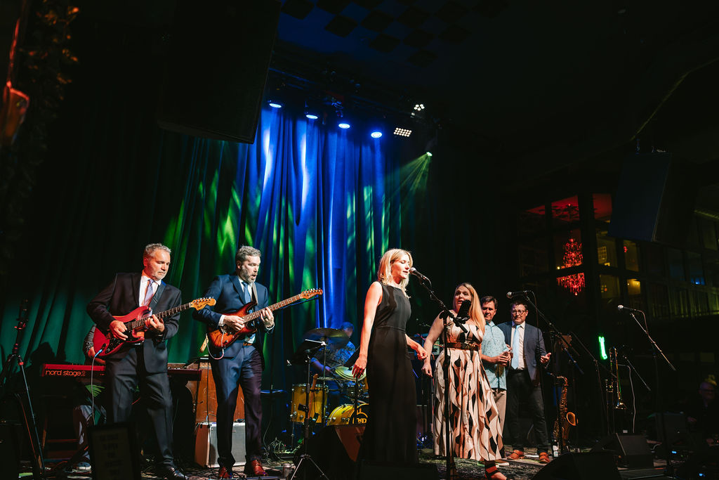Family performs on stage during Green Room wedding reception in Minneapolis
