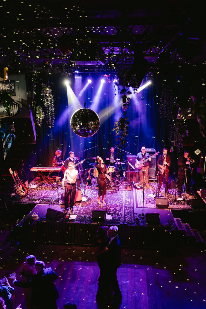 Groom and family perform on stage at Green Room Minneapolis