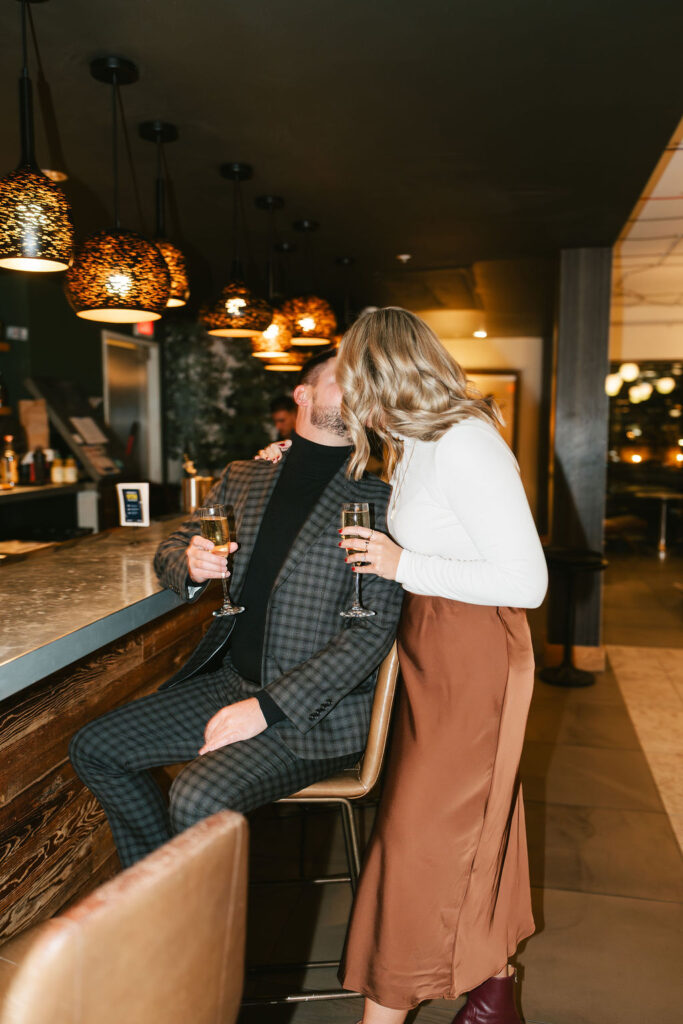 Bar couples photos in Hewing Hotel after a surprise proposal in Minneapolis