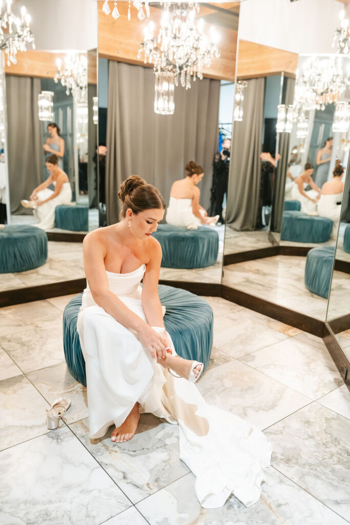 Bride putting on heels in the getting ready suite