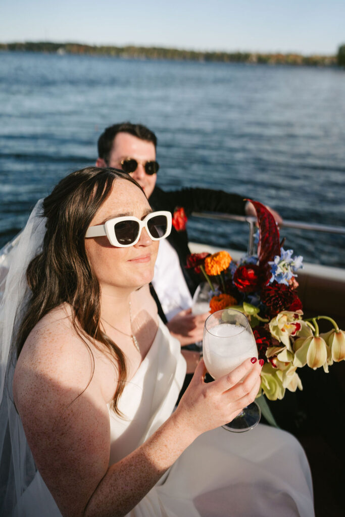 Bride and groom ride on a vintage boat on Gull Lake