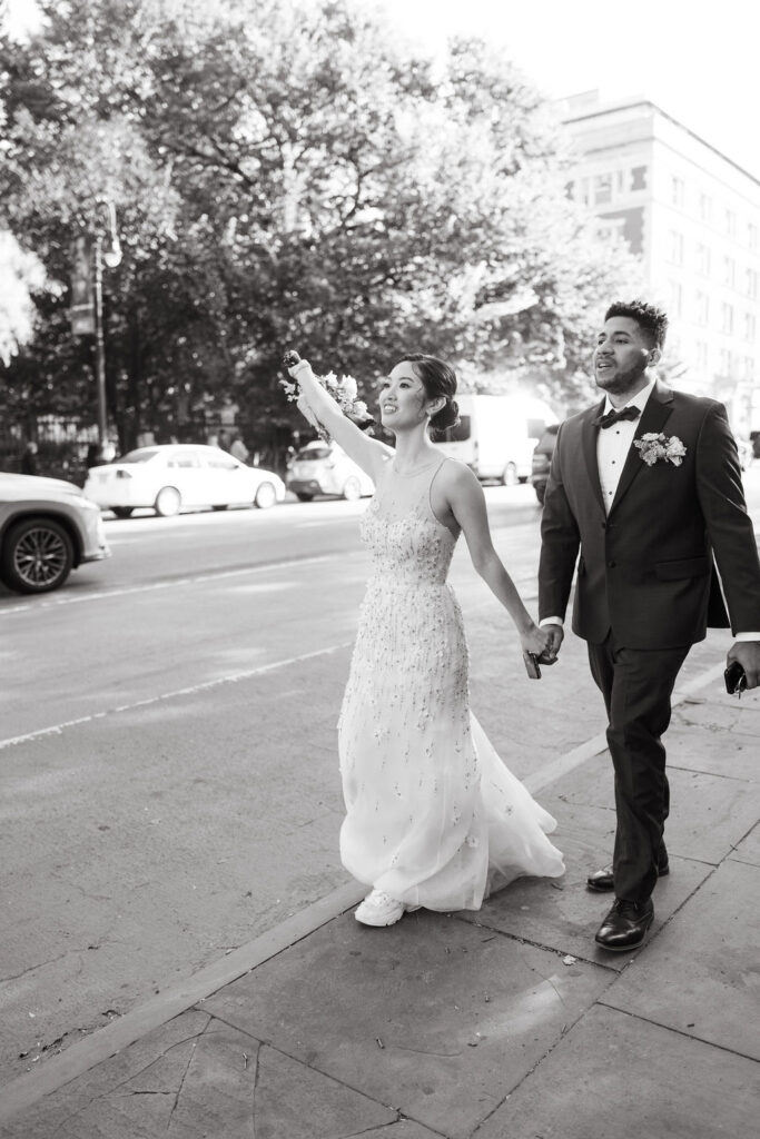 Bride and groom catch a taxi in Manhattan to head to their reception