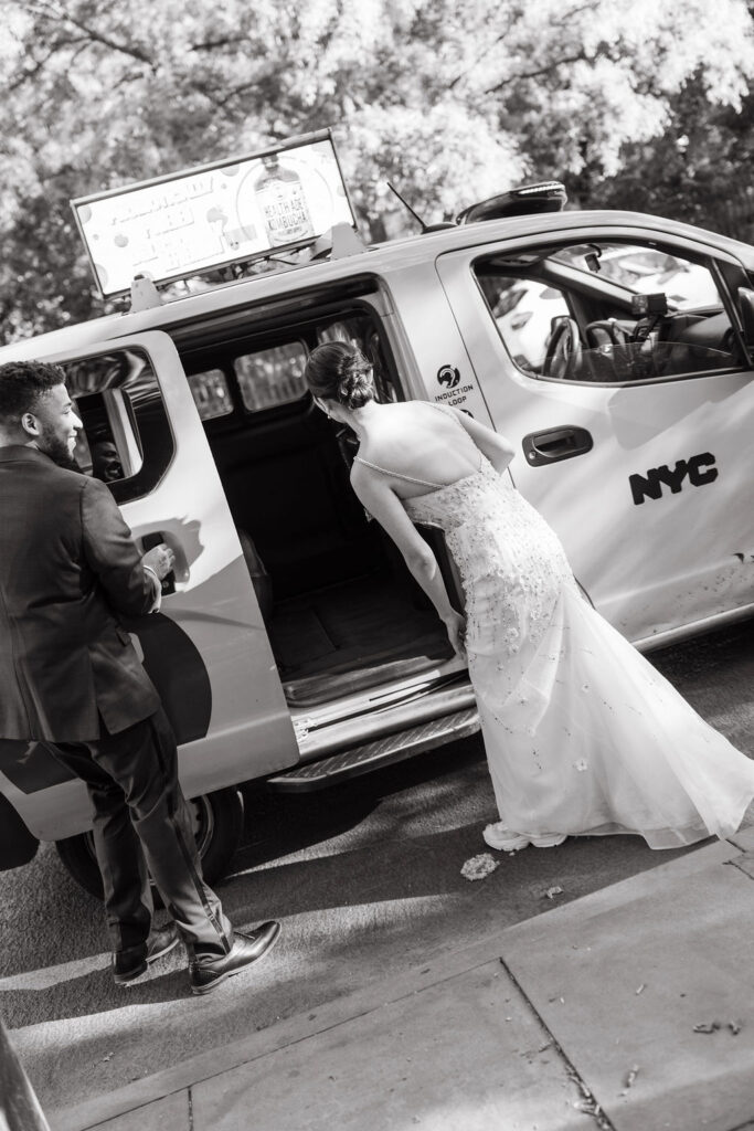 Bride and groom catch a taxi in Manhattan to head to their reception
