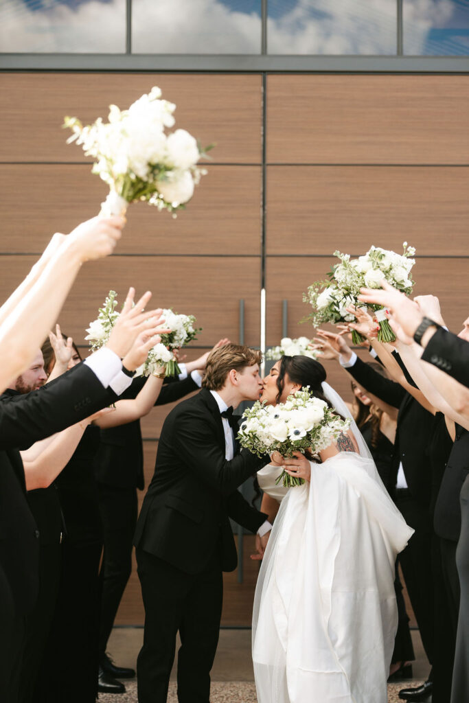 Bride and groom take photos with their wedding party at The Paseo wedding venue