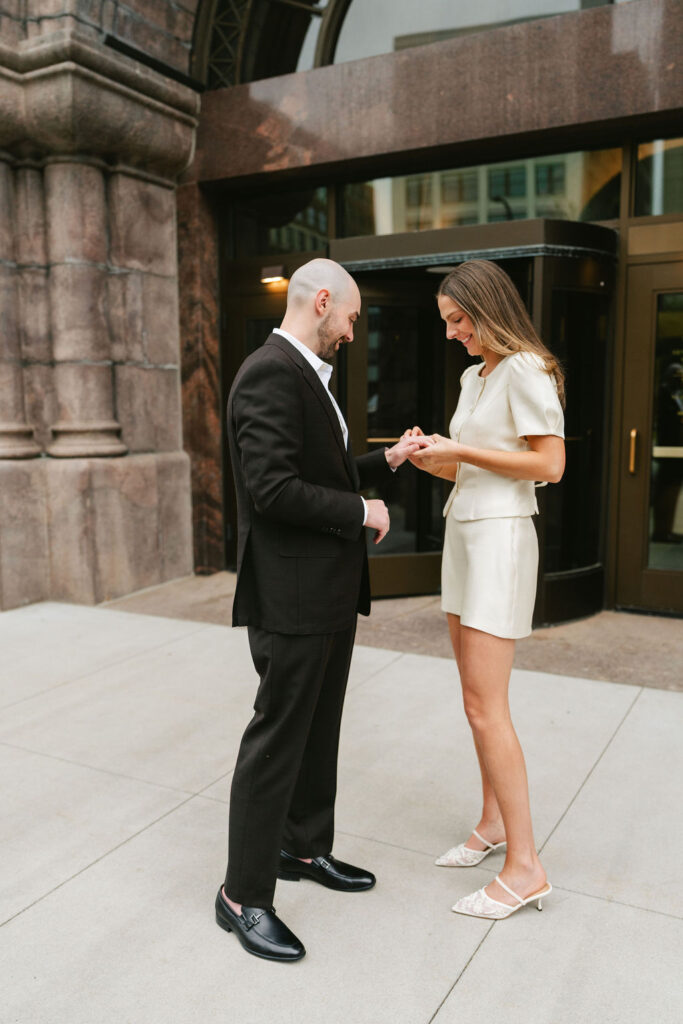 Bride and groom admire ring outside of Minneapolis City Hall