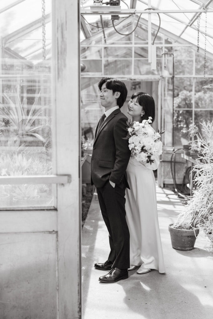 bride and groom in the greenhouse at Minnesota Landscape Arboretum