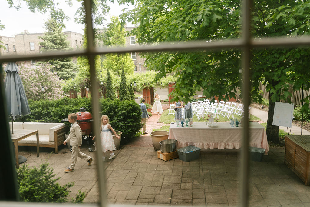 Kids wander around the ceremony space at a private estate in St. Paul